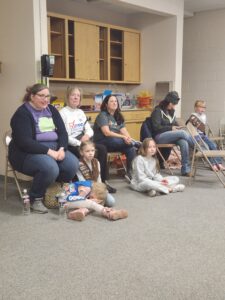 League members help girl scouts earn their democracy badges.